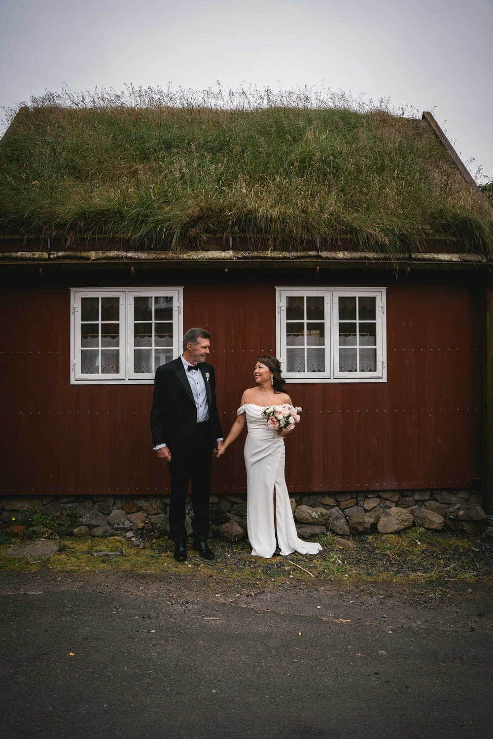 Couple eloping on a sea cliff above the ocean in the Faroe Islands