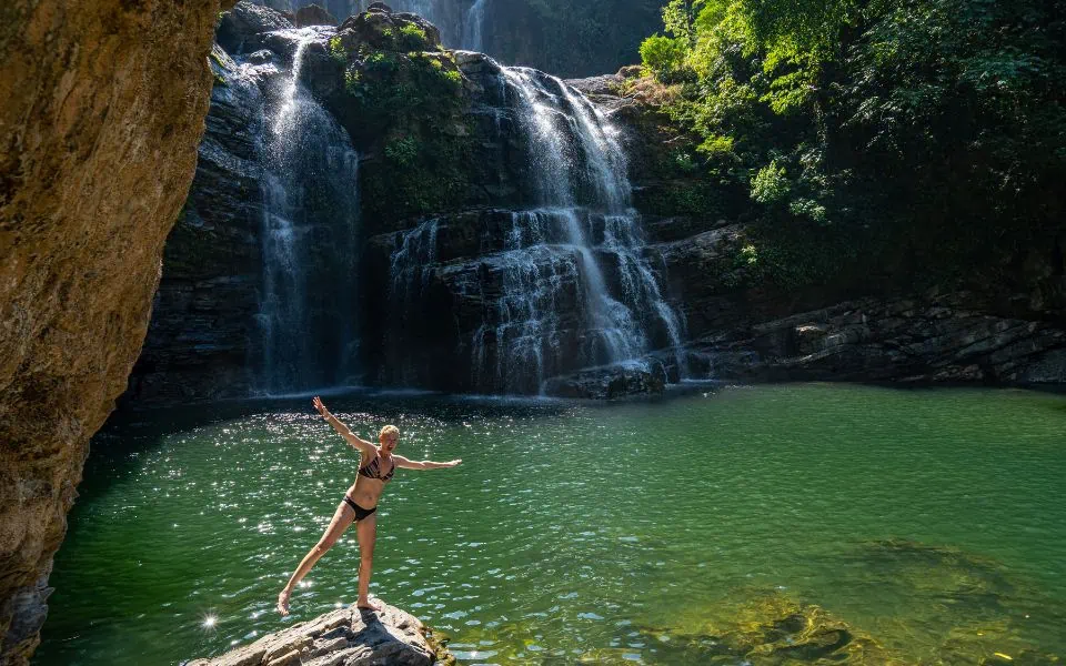 What to do on your Costa Rica elopement - realistic photo Cliff Jumping in Nauyaca Waterfall