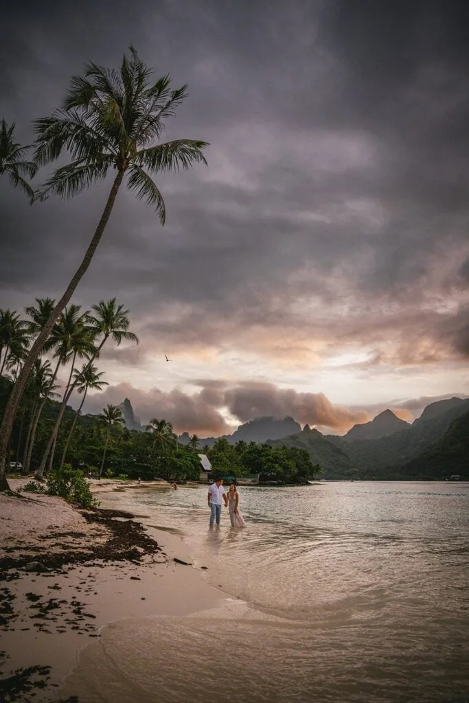 Elopement on Bora Bora beach with couple and scenic mountain backdrop.