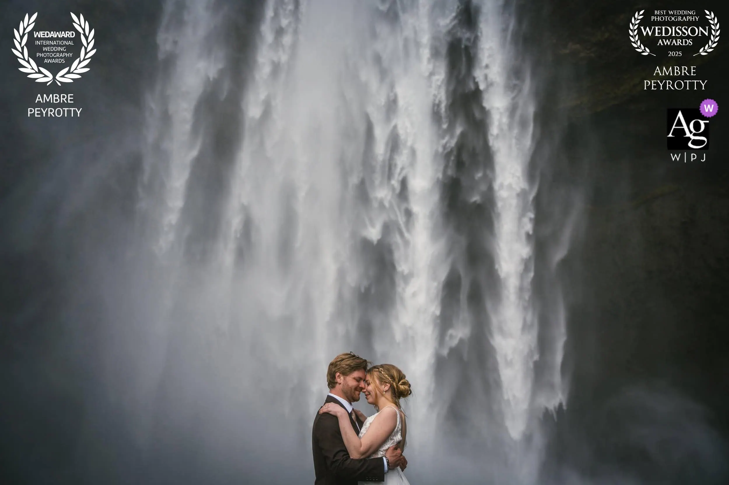Elopement couple embracing under a waterfall in French Polynesia.