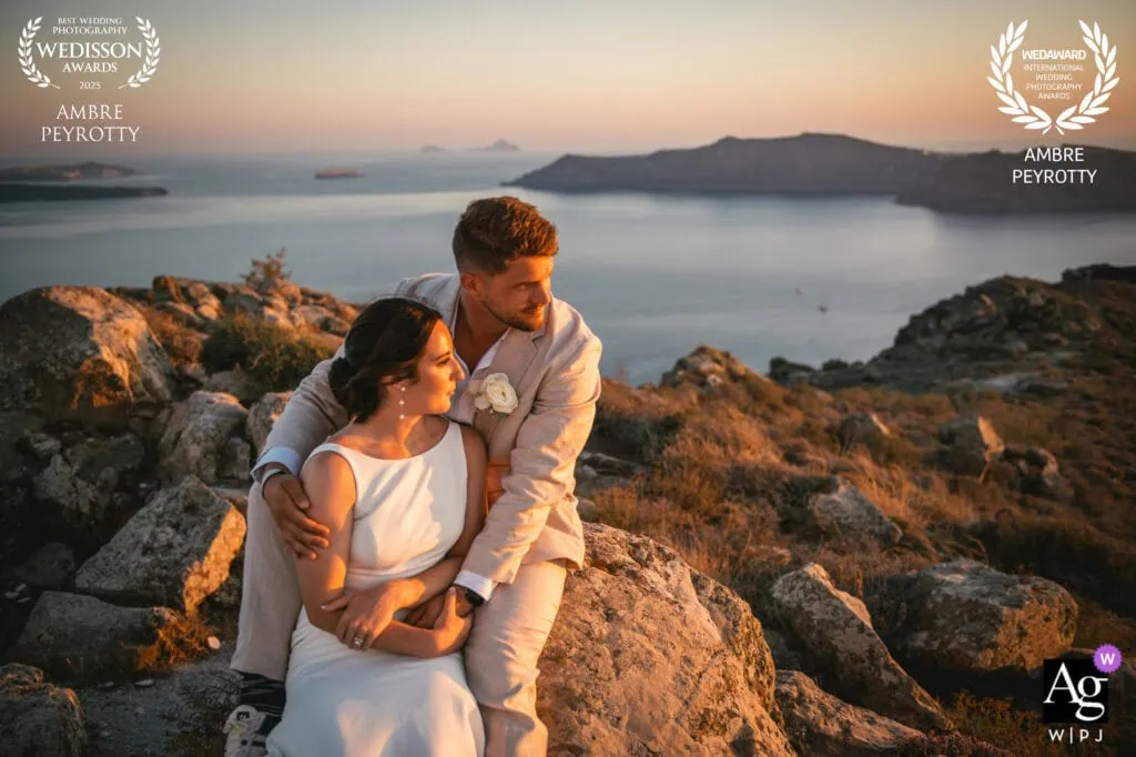 Romantic couple embracing during sunset on rocky coastline in Italy.