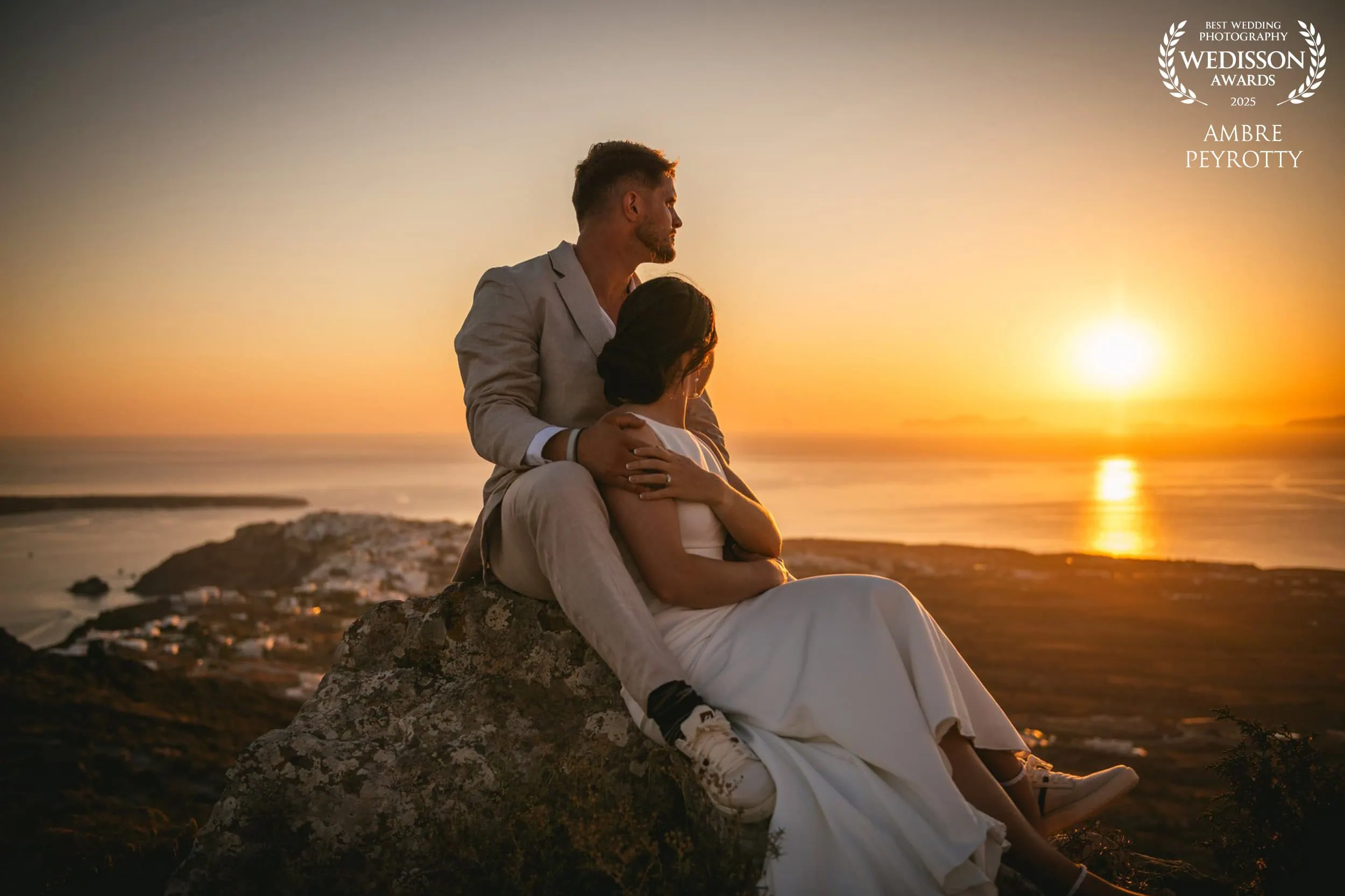 Couple embracing on a rocky beach during sunset in Italy, capturing romantic elopement moments.