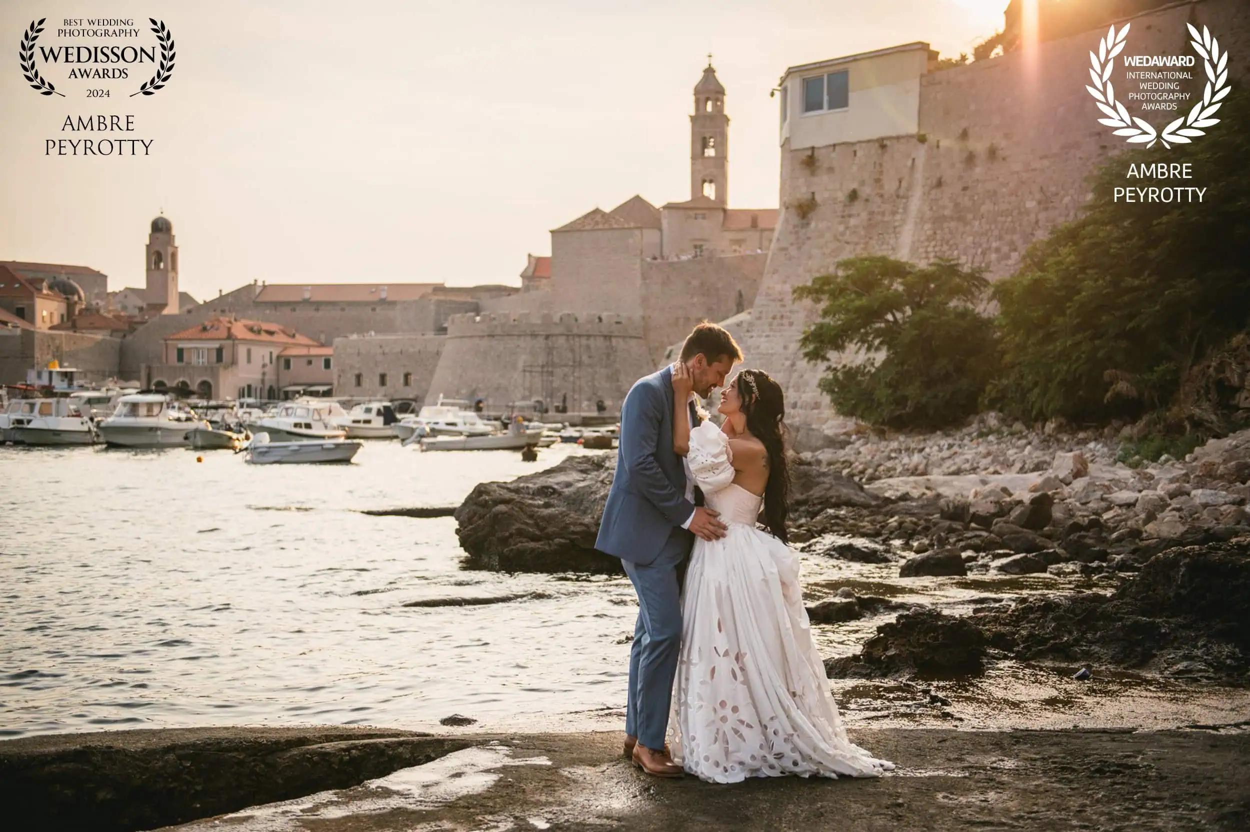 Romantic couple sharing a kiss during their Italy elopement by the harbor at sunset.