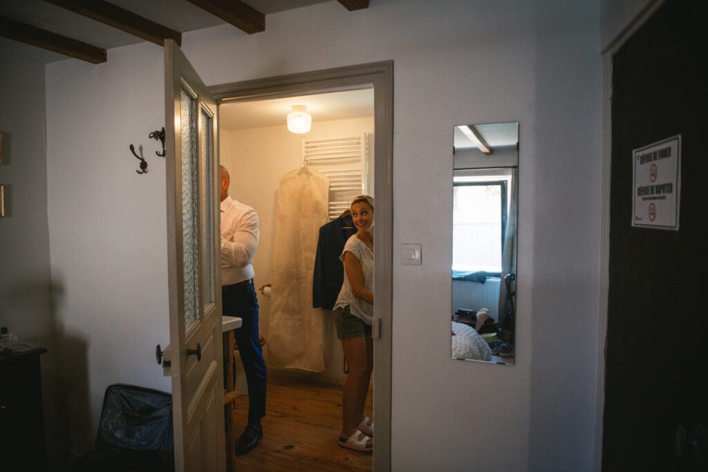 Bride and groom getting ready in their bathroom before their elopement in Central France