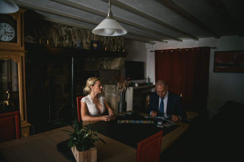 Bride and groom playing a board game on their elopement day in Central France