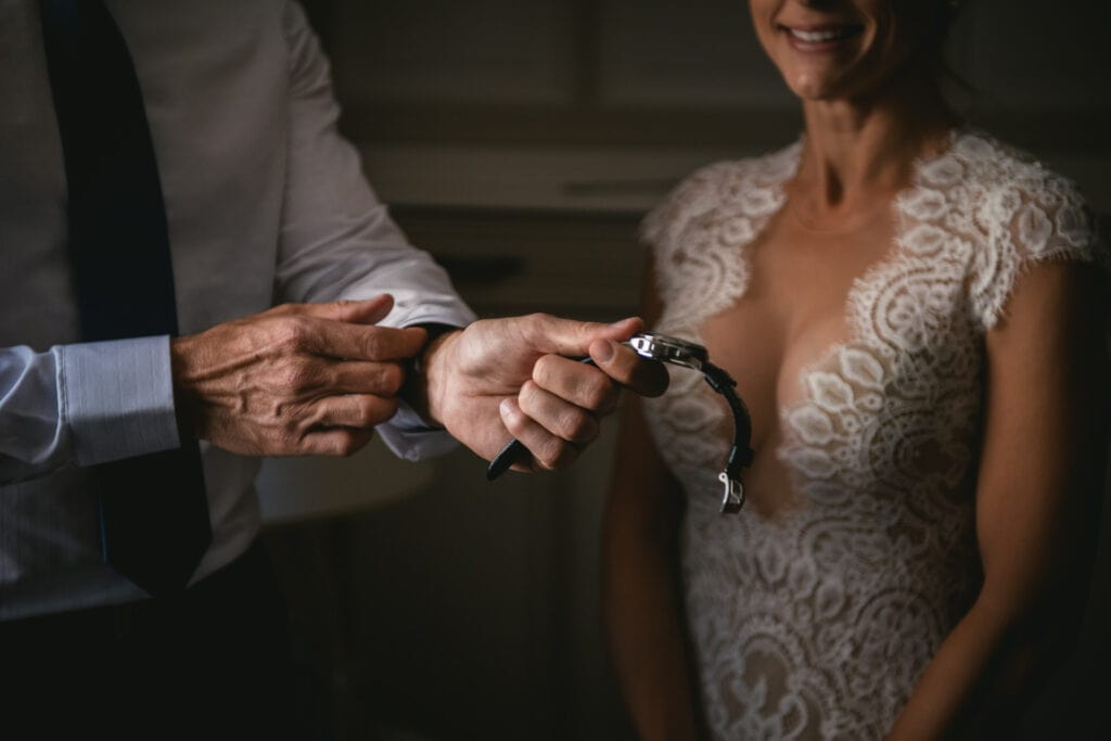 Groom putting his watch on on his elopement day in Central France