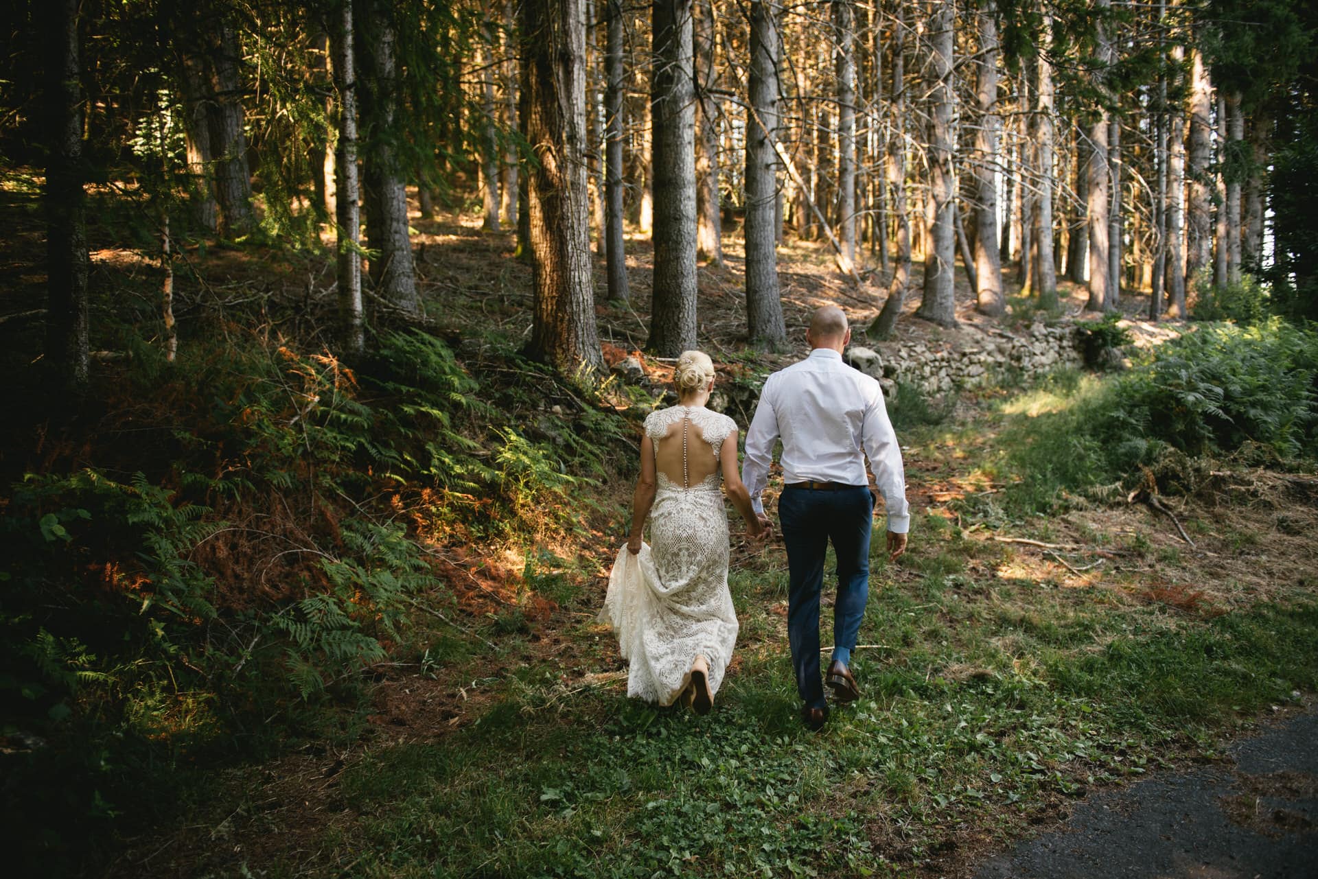 Bride and groom walking in the forest during their elopement in Central France