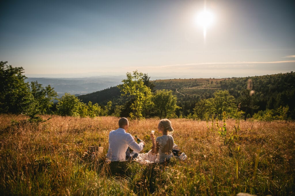 Bride and groom enjoying a picnic at sunset after their elopement in Central France