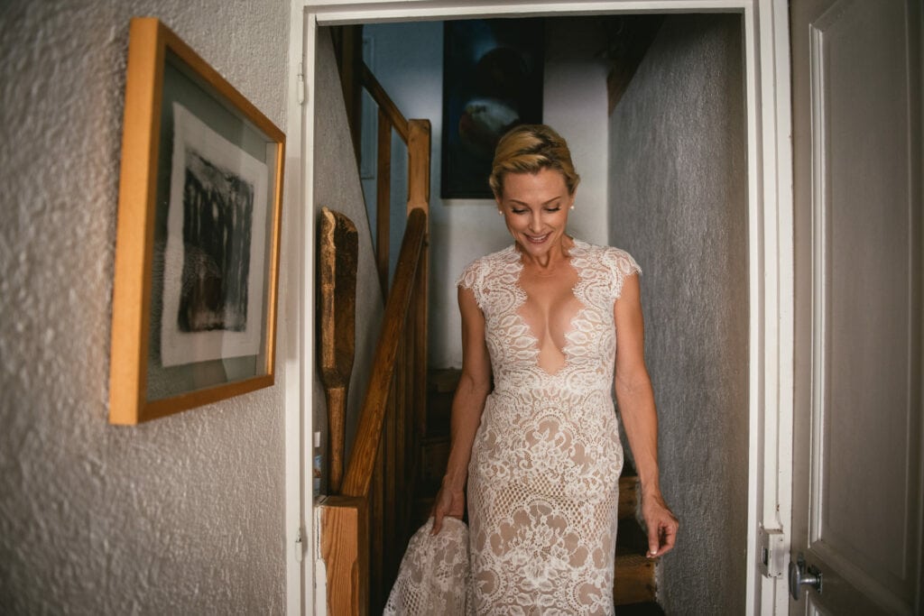 Bride going down the stairs before the first look on her elopement in Central France