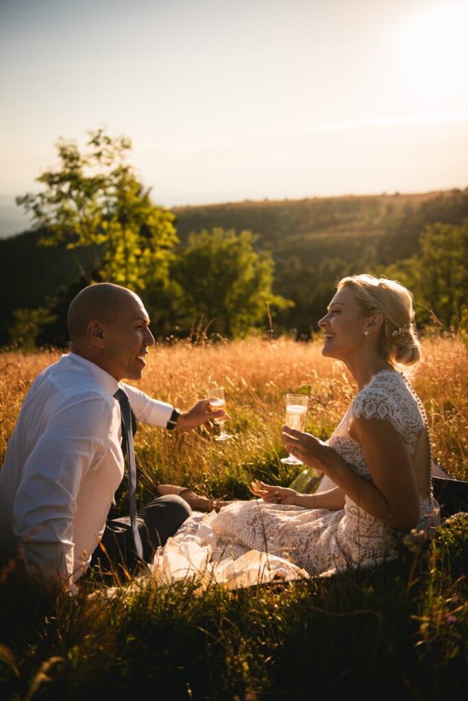 Bride and groom chatting during their sunset picnic after their elopement in Central France