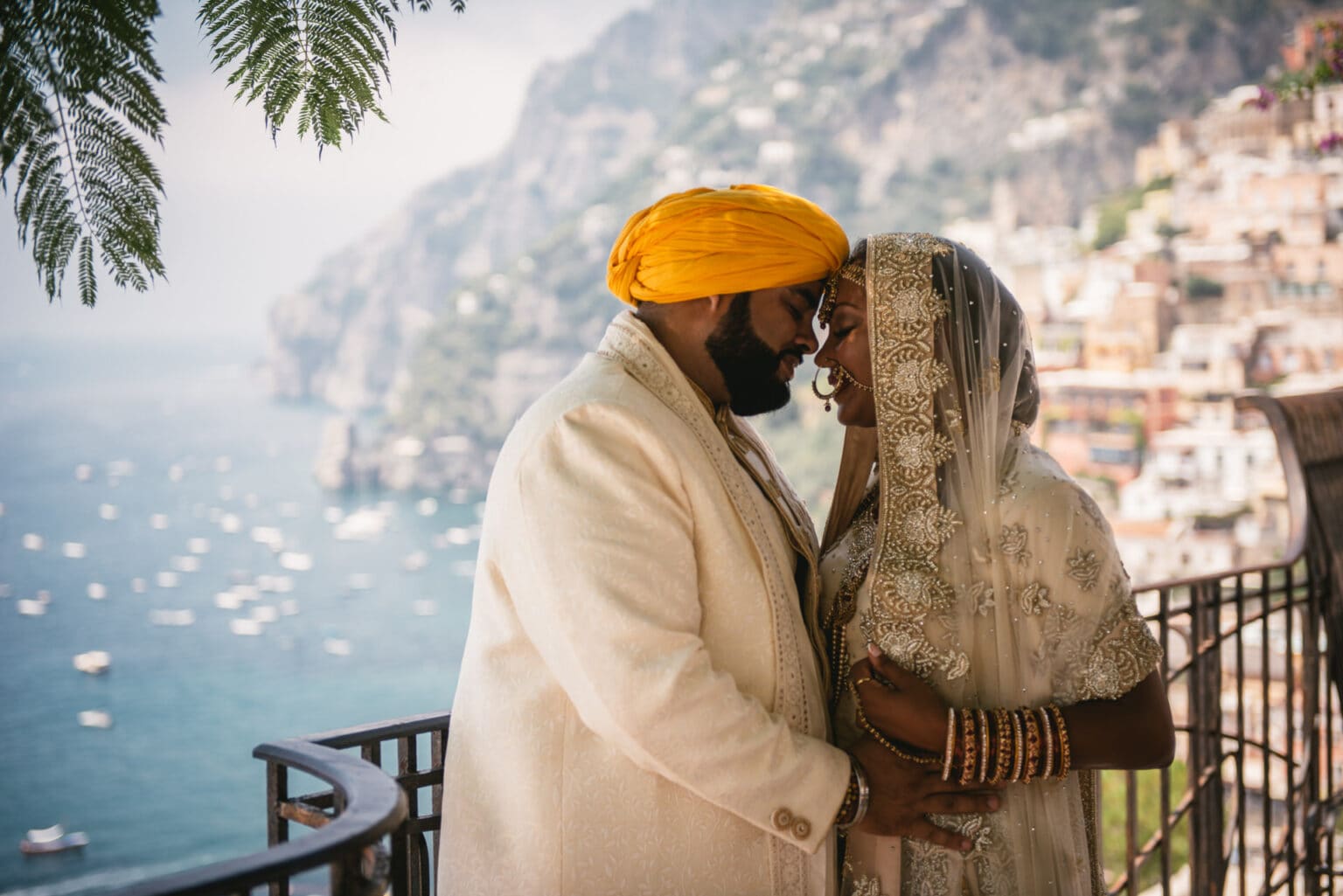 Couple in their traditional Sikh wedding outfits posing in the streets of Positano during their elopement on the Amalfi Coast