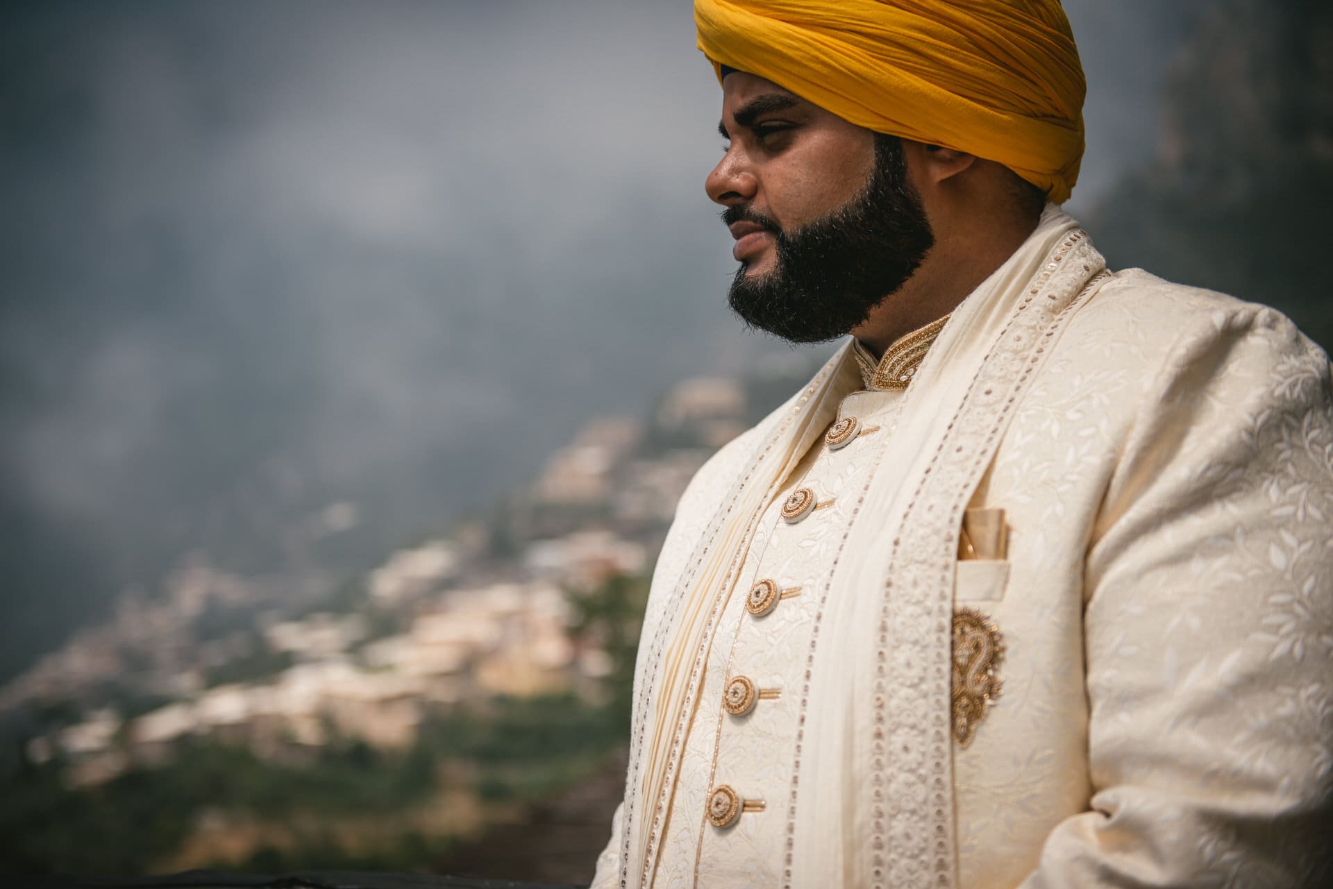 Groom in his Sikh wedding attire with Positano in the background on his elopement day
