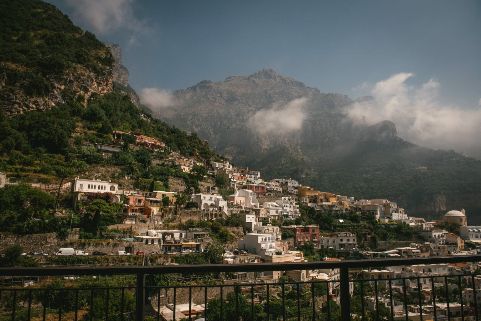 Positano from the road, with the mountains of the Amalfi Coast on a misty morning
