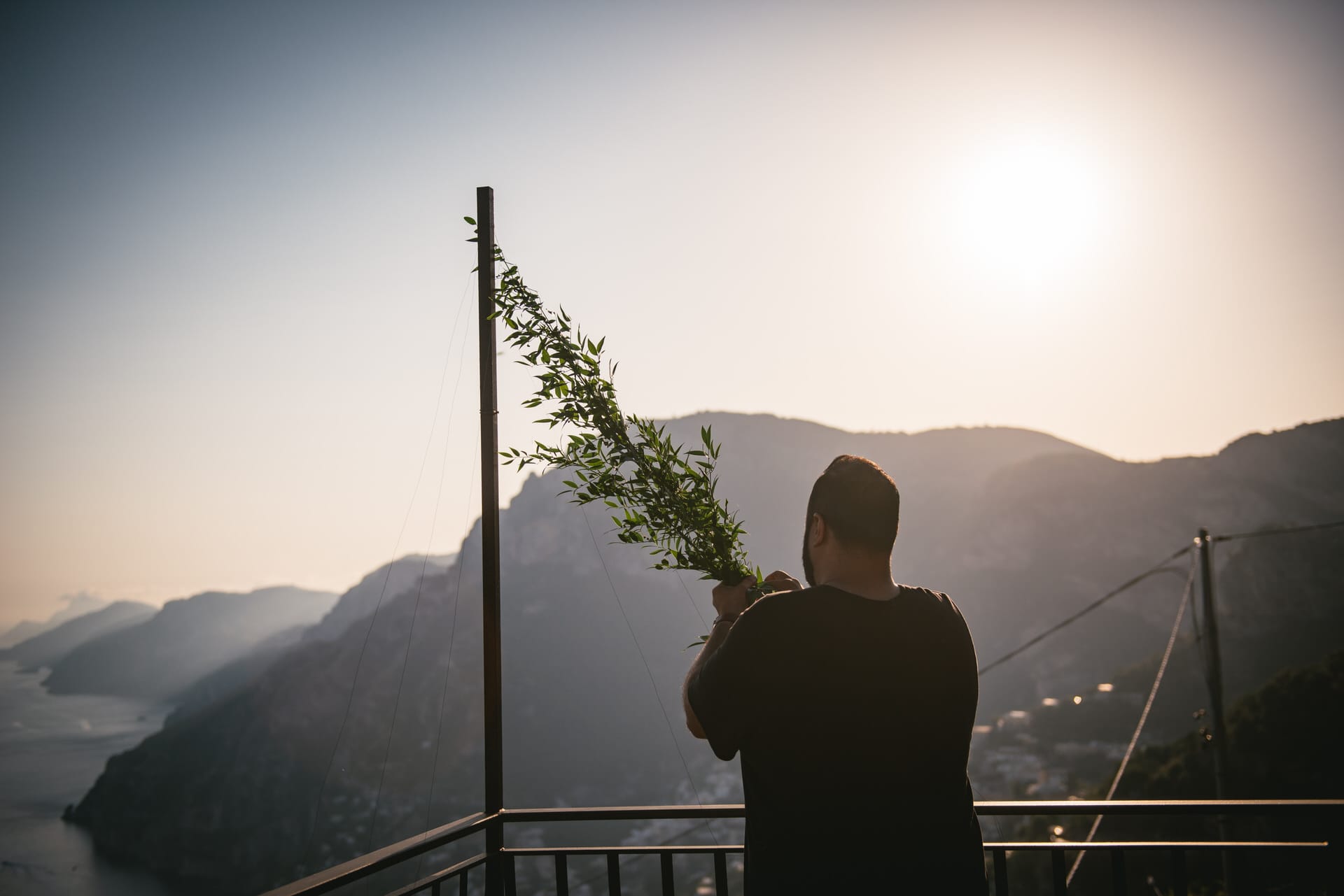 Groom setting up the ceremony on his elopement in Positano