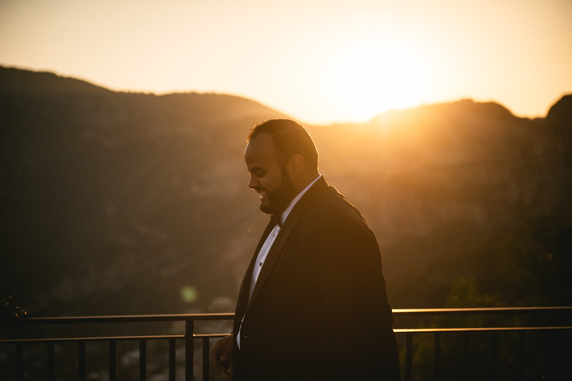 Groom walking up to his ceremony site in Positano at sunset