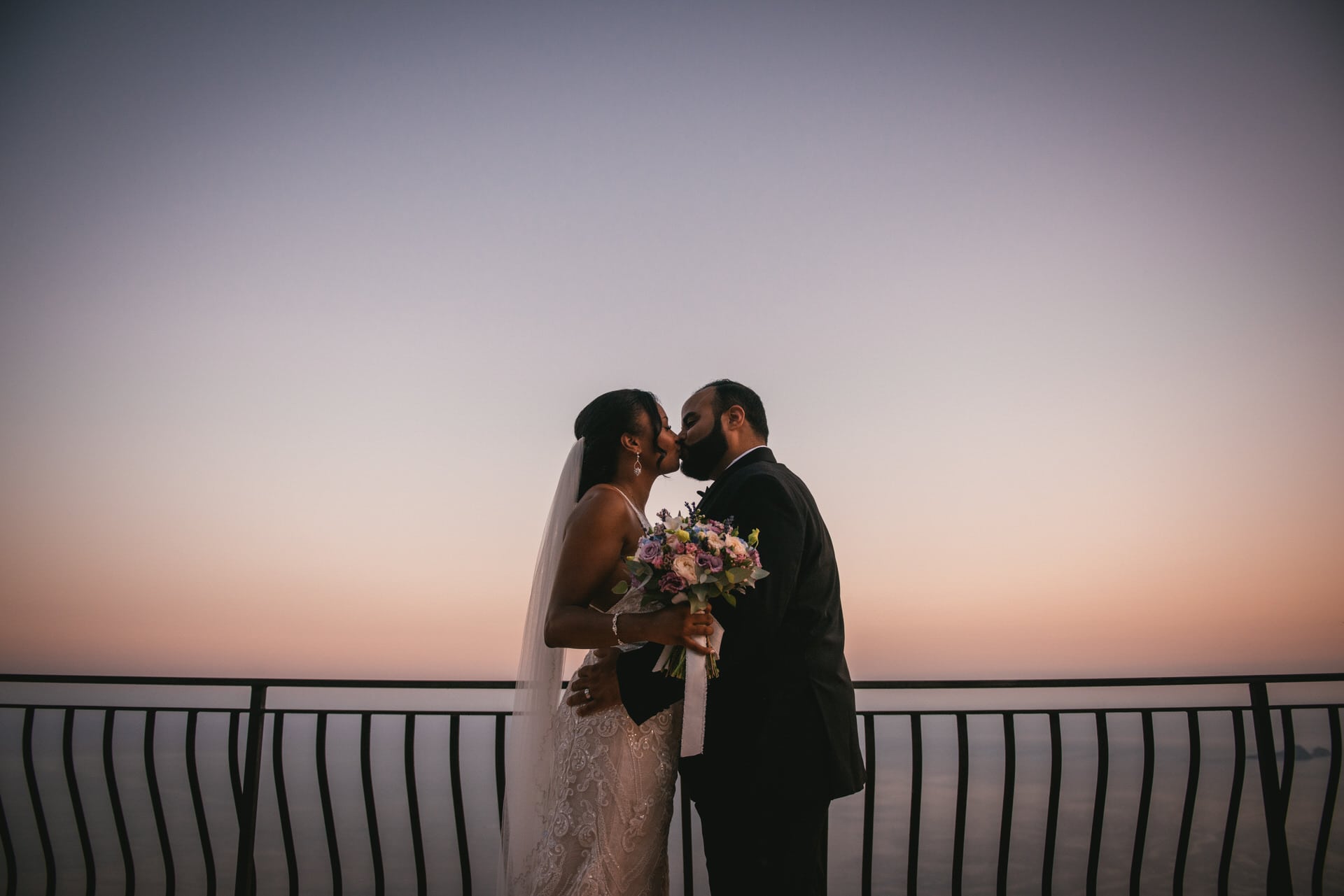 Bride and groom posing for a photoshoot at sunset after their elopement on the Amalfi Coast