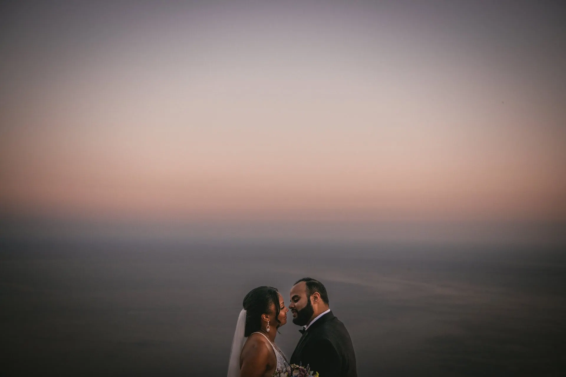 Bride and groom posing for a photoshoot at sunset after their elopement on the Amalfi Coast
