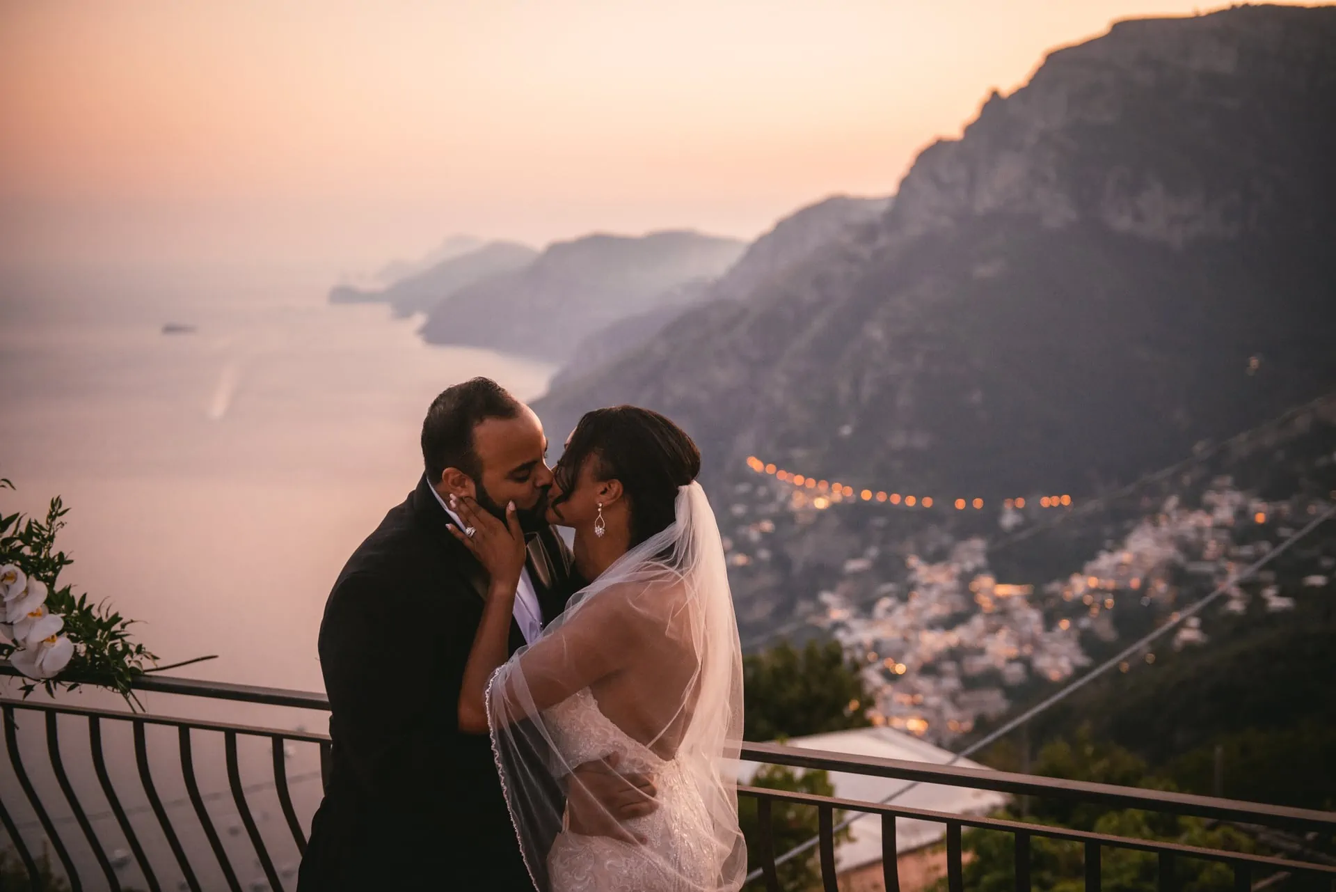 Bride and groom posing for a photoshoot at sunset after their elopement on the Amalfi Coast