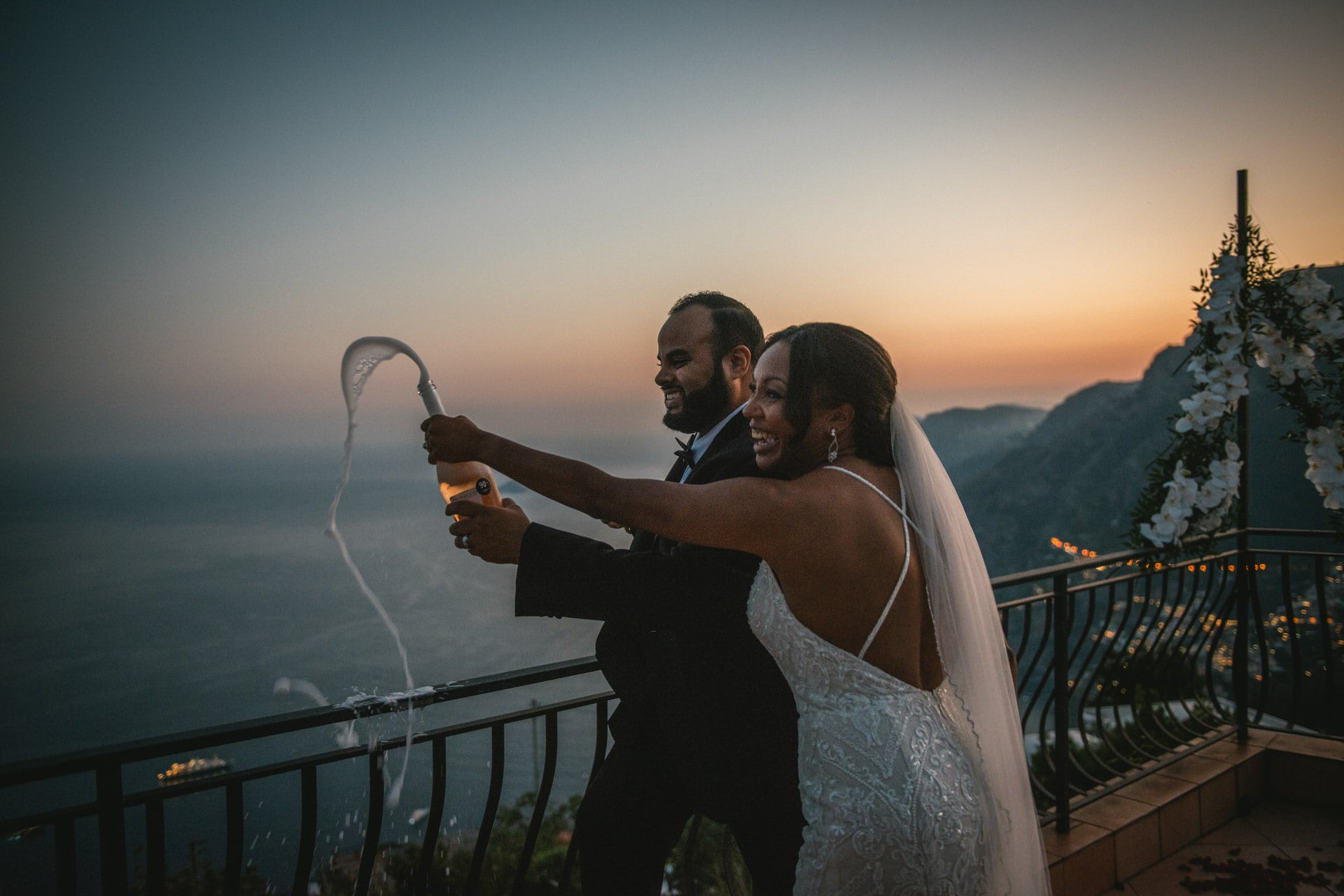 Bride and groom drinking champagne after their elopement in Positano