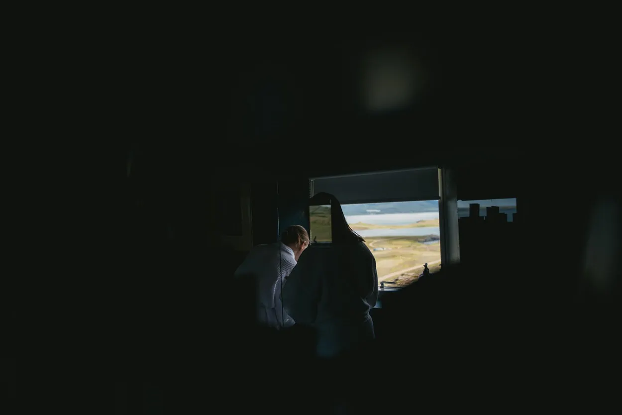 Brides getting ready in the bathroom of their cottage in Iceland