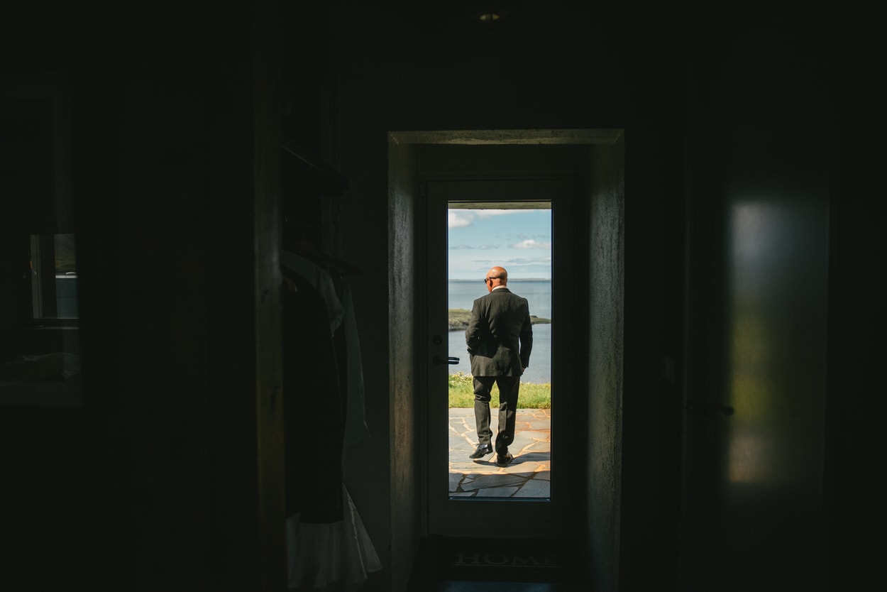 Father of the bride waiting patiently outside their cottage in Iceland until they are ready for the ceremony