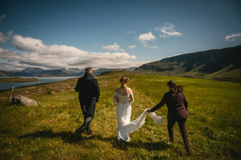 Brides walking towards their ceremony site with their celebrant in Iceland