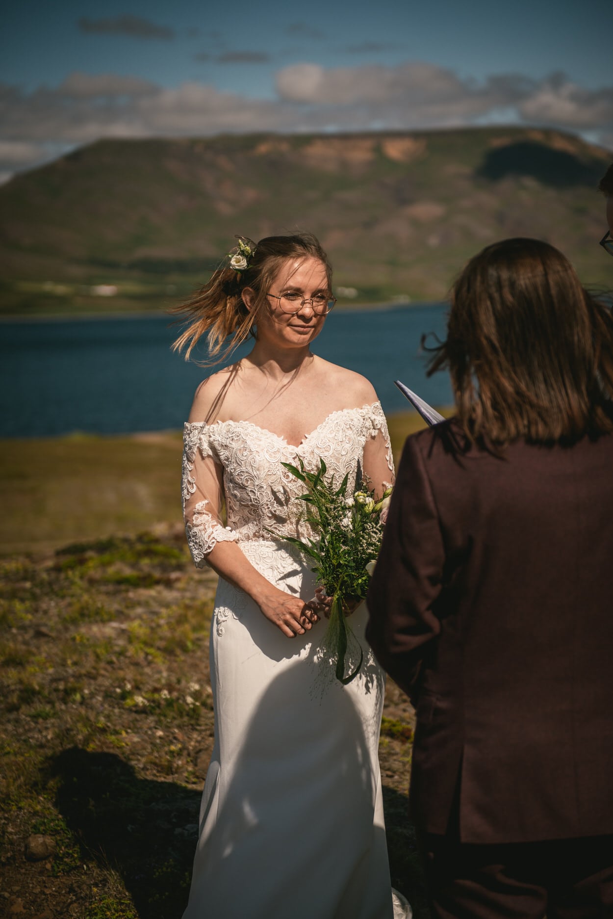 Bride listening to the vows of her bride during their elopement ceremony in Iceland