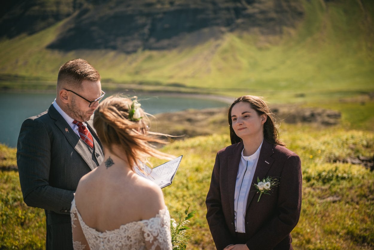 Bride listening to the vows of her bride during their elopement ceremony in Iceland