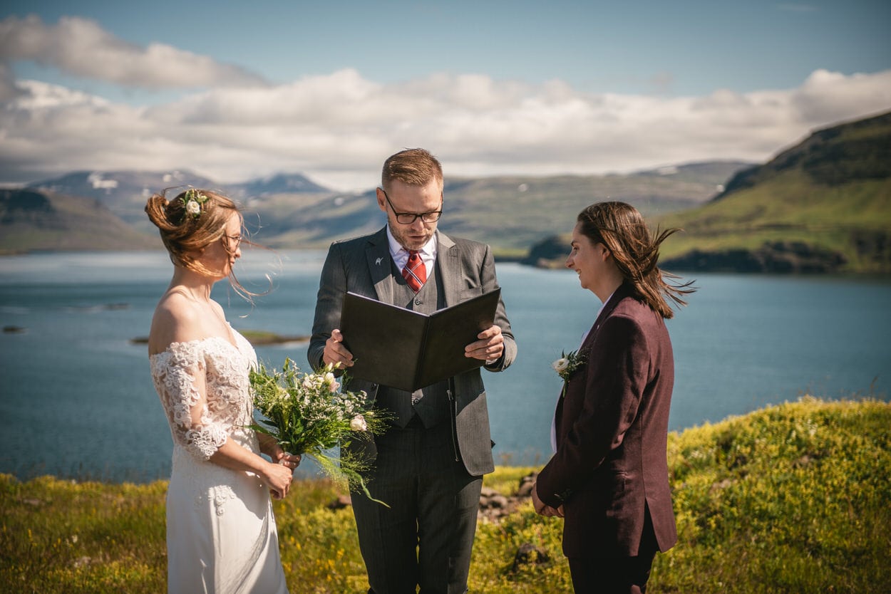 Same-sex couple having their ceremony in the bay of Iceland