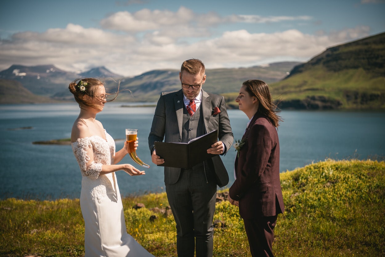 Brides drinking their own brewed beer to toast for their elopement ceremony in Iceland