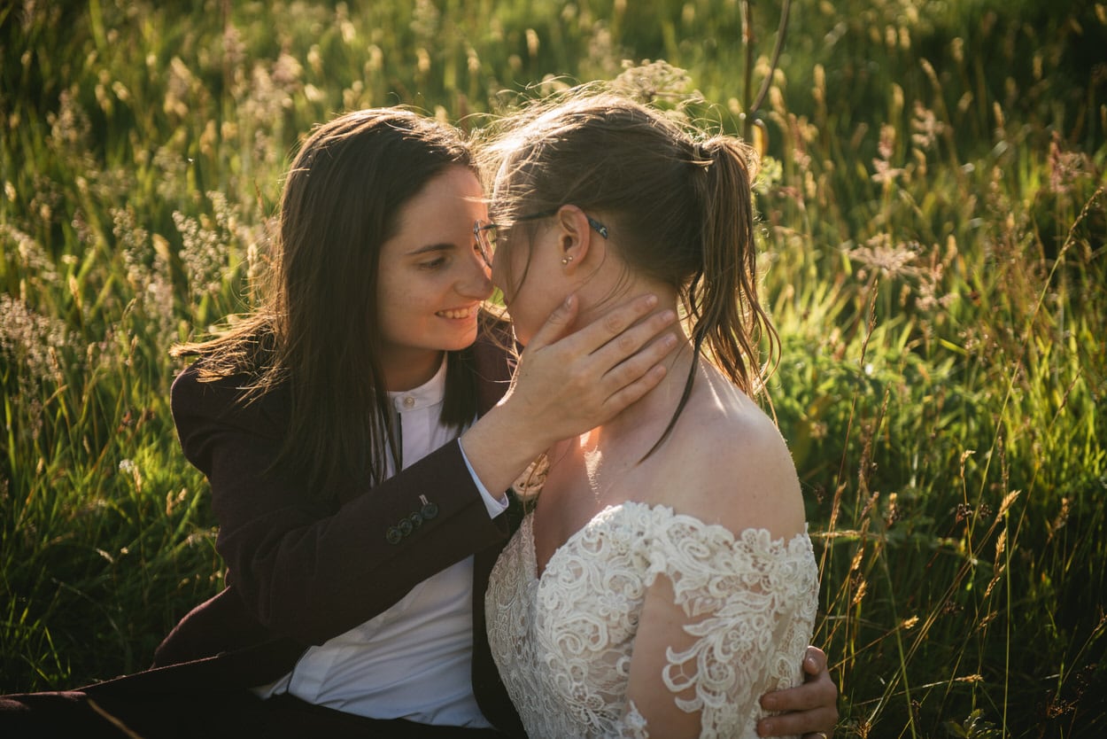 Same-sex couple in the grass after their elopement ceremony in Iceland