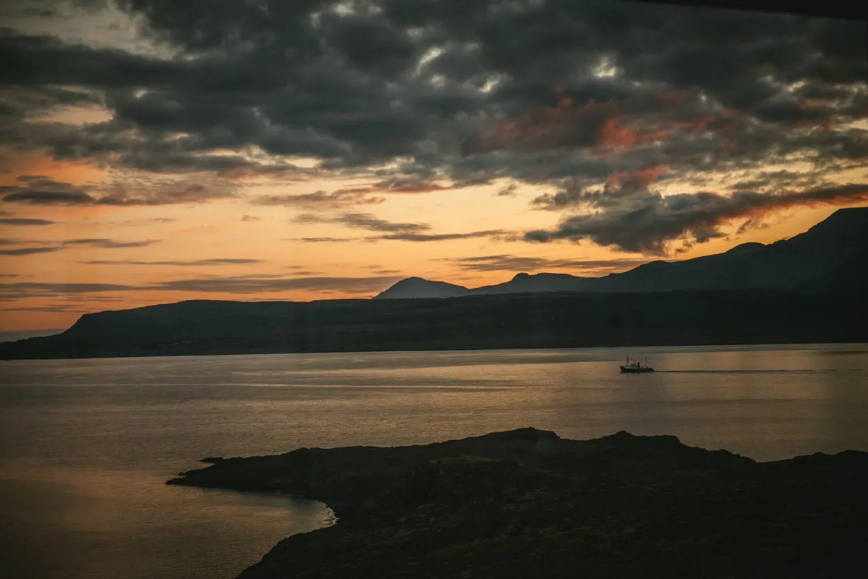 Sunset in an icelandic bay with a fisherman's boat