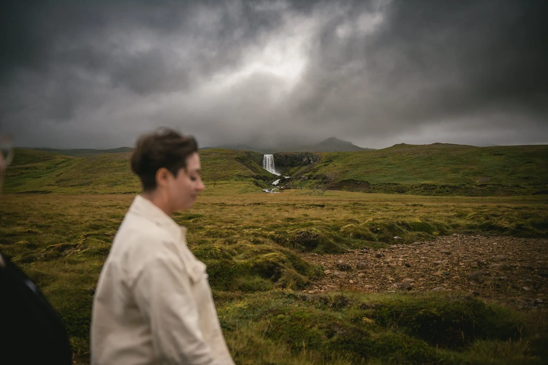 Bride walking in the Icelandic moss with Grundarfoss in the background