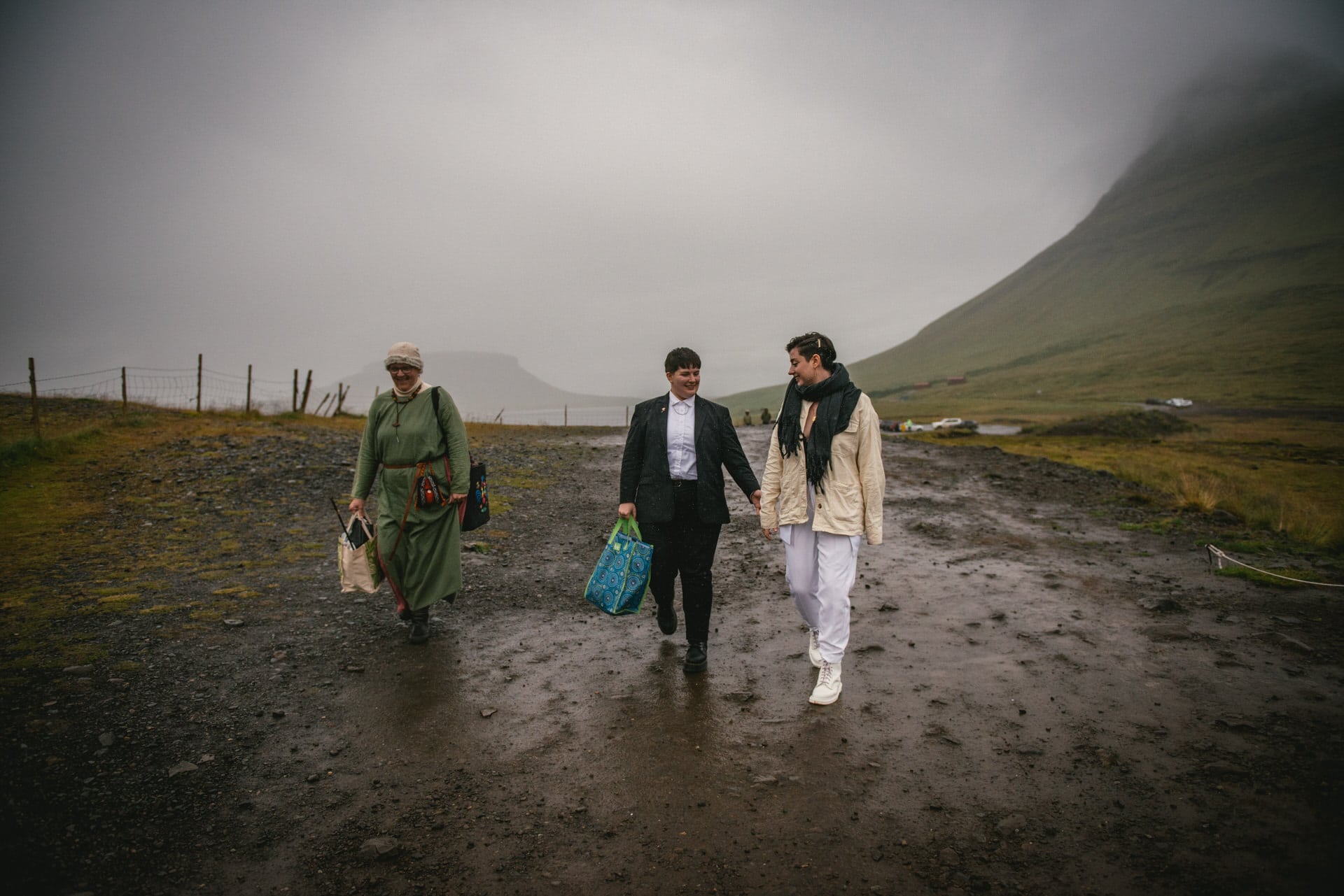 Couple walking with their priestess on their elopement day in Iceland