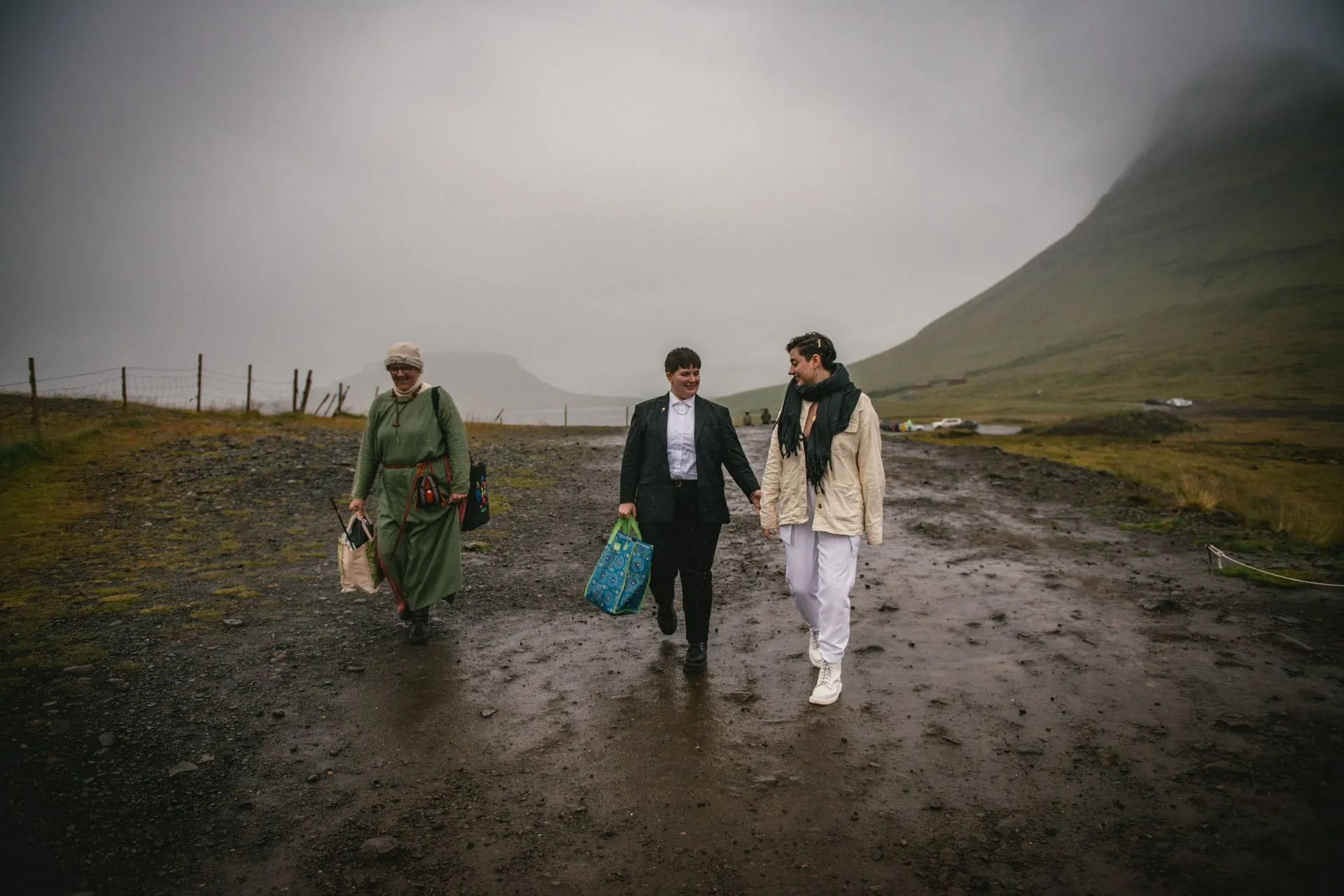 Couple walking with their priestess on their elopement day in Iceland