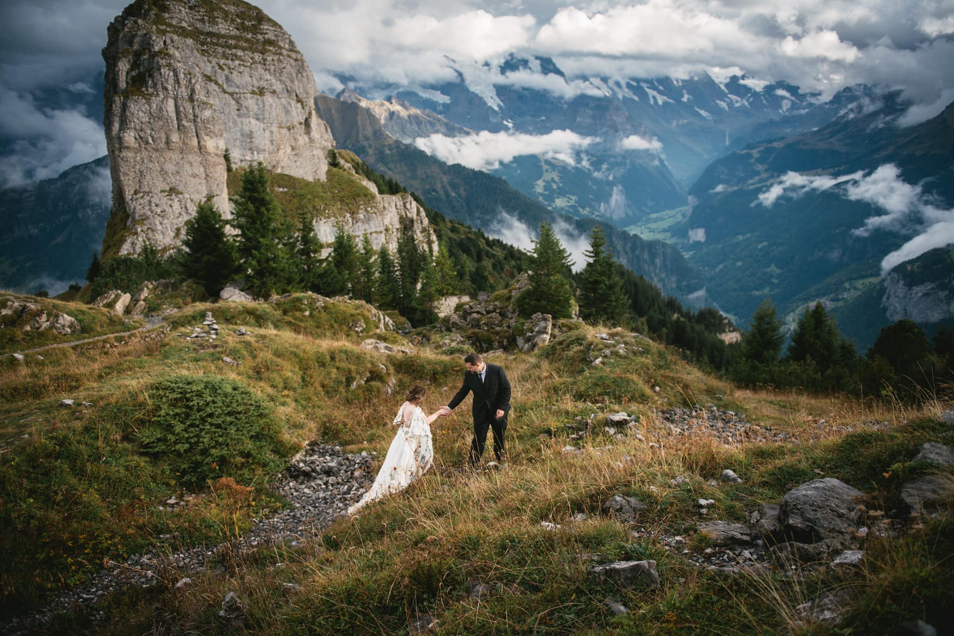 Couple walking in the mountains for an elopement photoshoot in Switzerland
