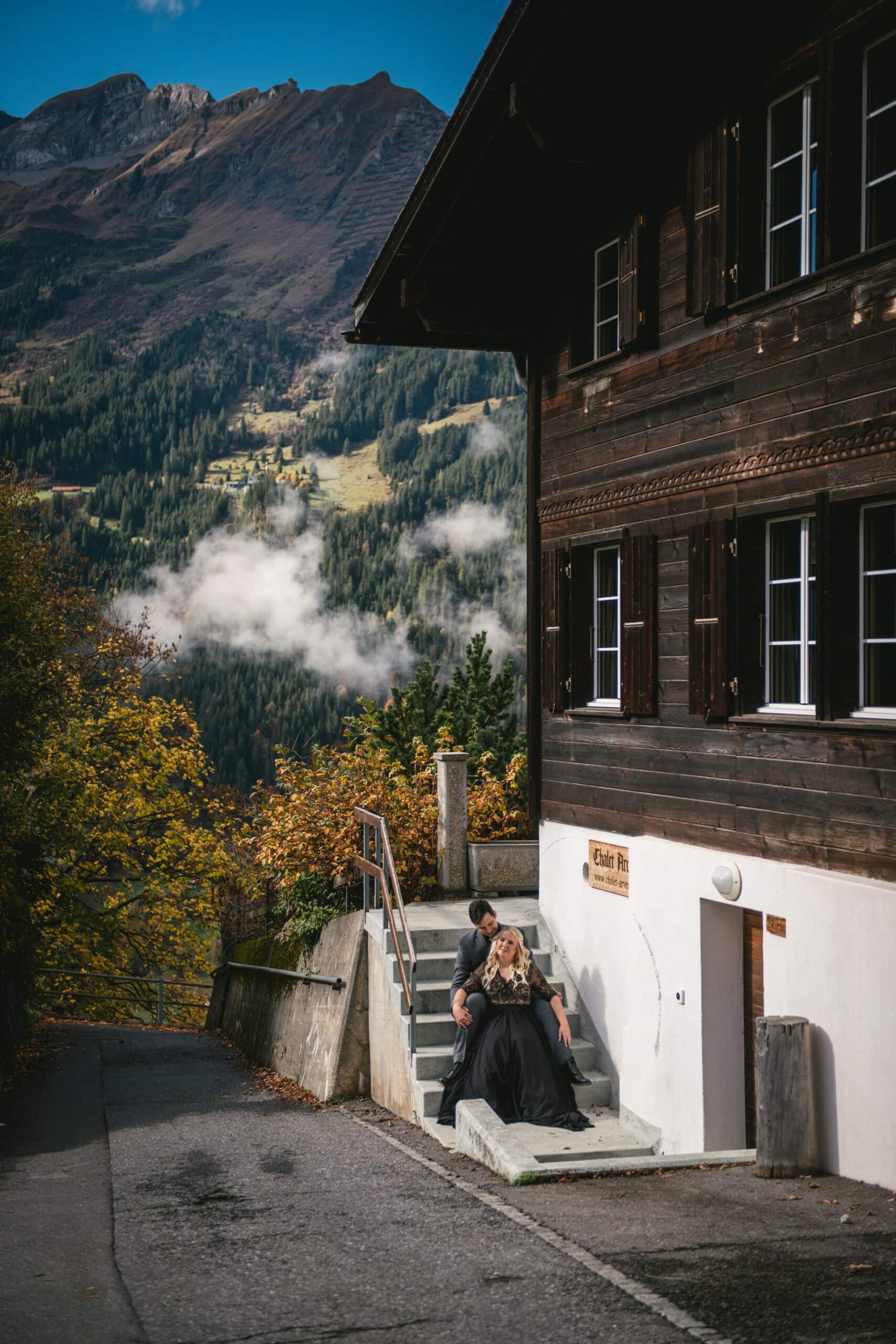 Couple cuddling with the Lauterbrunnen valley in the background