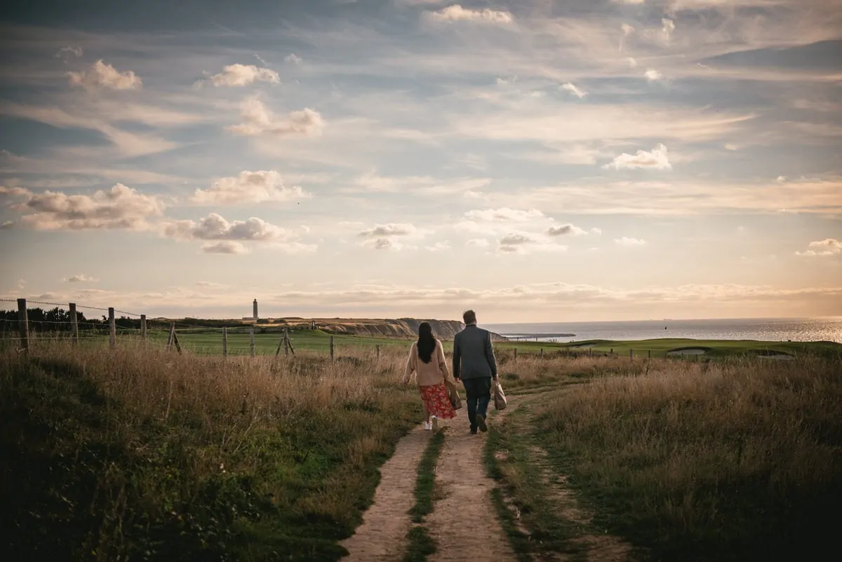 Couple walking to the cliffs of Etretat for a picnic