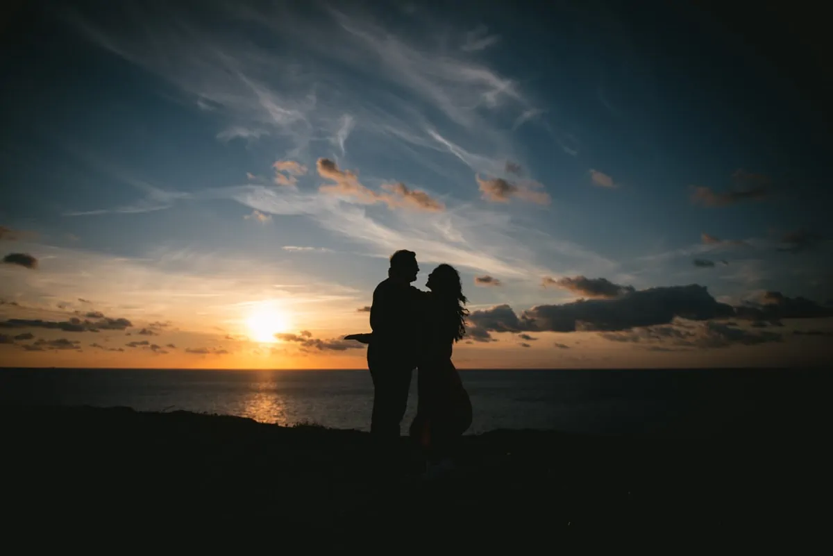 Couple hugging on top of the Etretat cliffs Couple hugging with the Etretat cliffs in the background before their elopement in Normandy