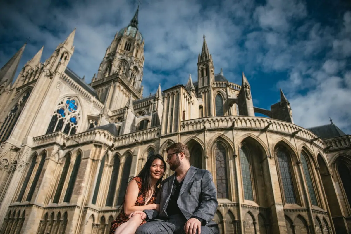 Couple posing at the Bayeux Cathedral before their elopement in Normandy