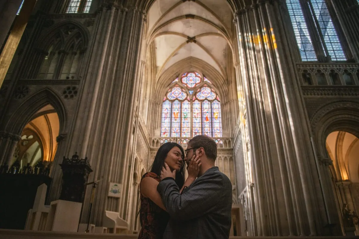 Couple posing at the Bayeux Cathedral before their elopement in Normandy
