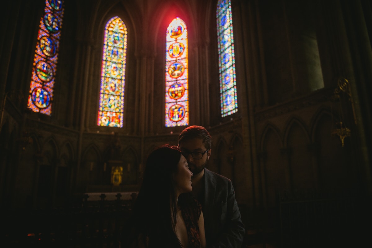 Couple posing at the Bayeux Cathedral before their elopement in Normandy