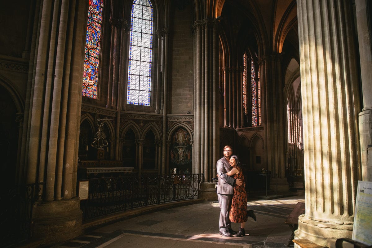 Couple posing at the Bayeux Cathedral before their elopement in Normandy