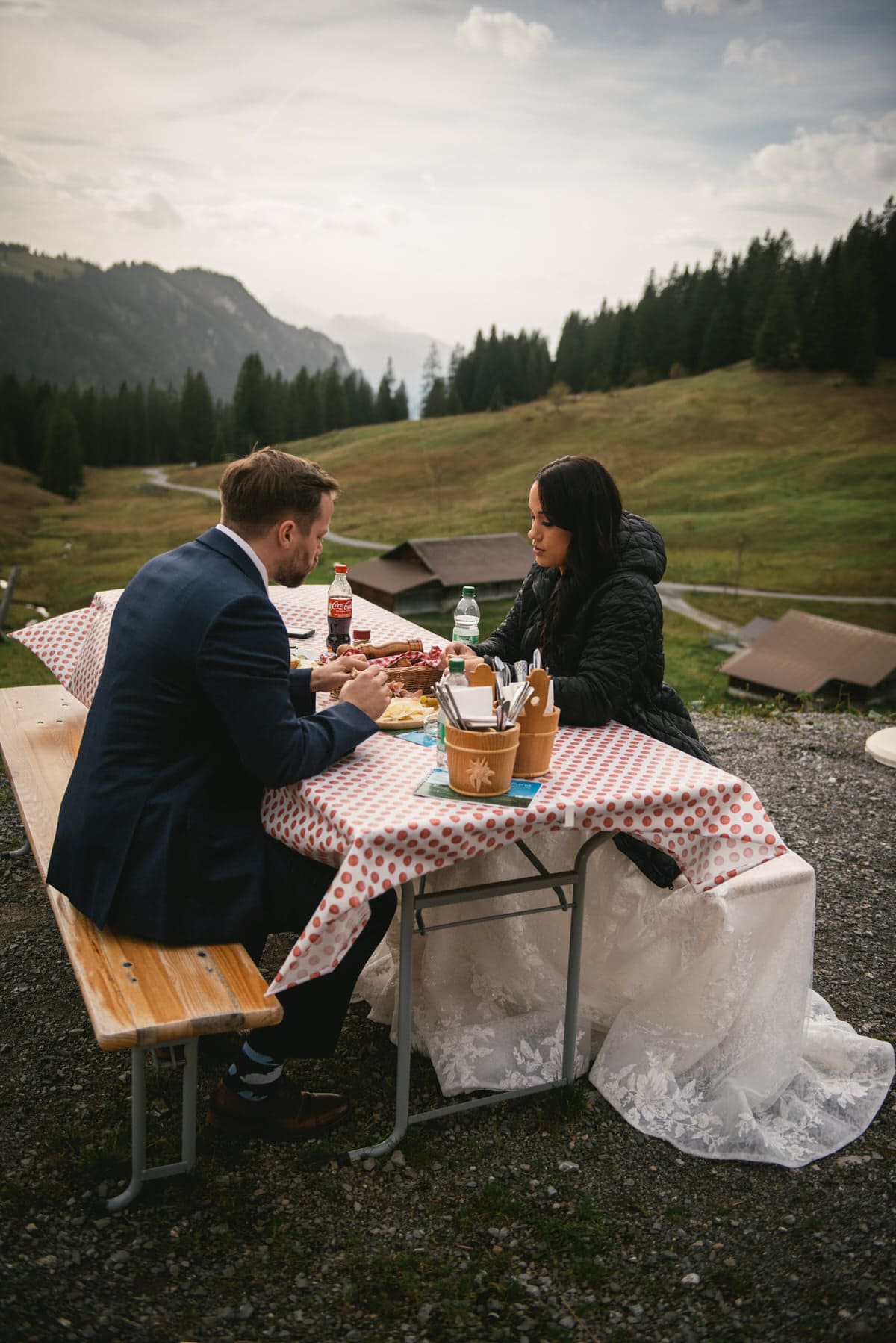 Couple on their elopement day in the Interlaken region of Switzerland - eating lunch at an altitude restaurant