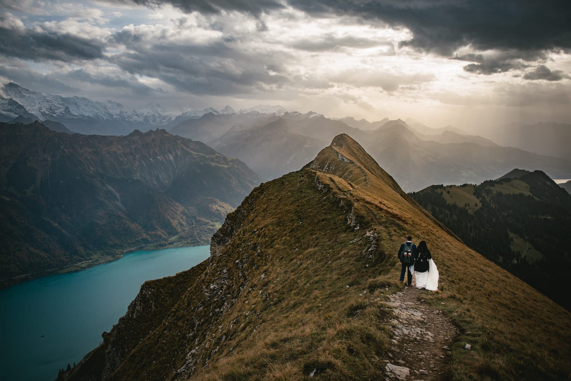 Couple on their elopement day in the Interlaken region of Switzerland - couple hiking to their ceremony spot