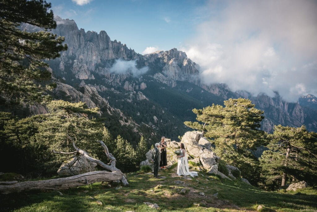Intimate outdoor wedding in nature with stunning mountain views and lush greenery.