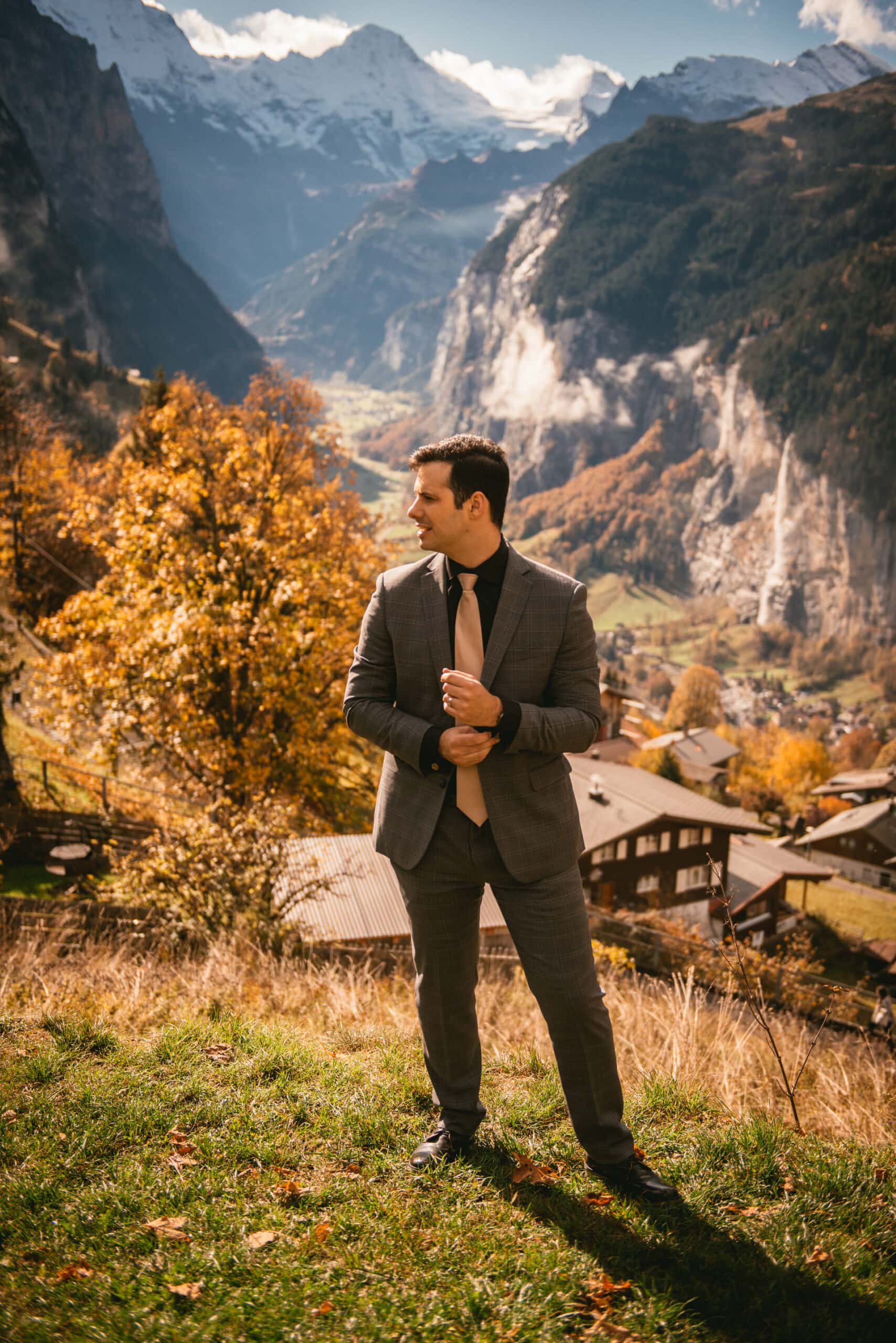 Groom posing on their elopement day in Switzerland in the Lauterbrunnen valley