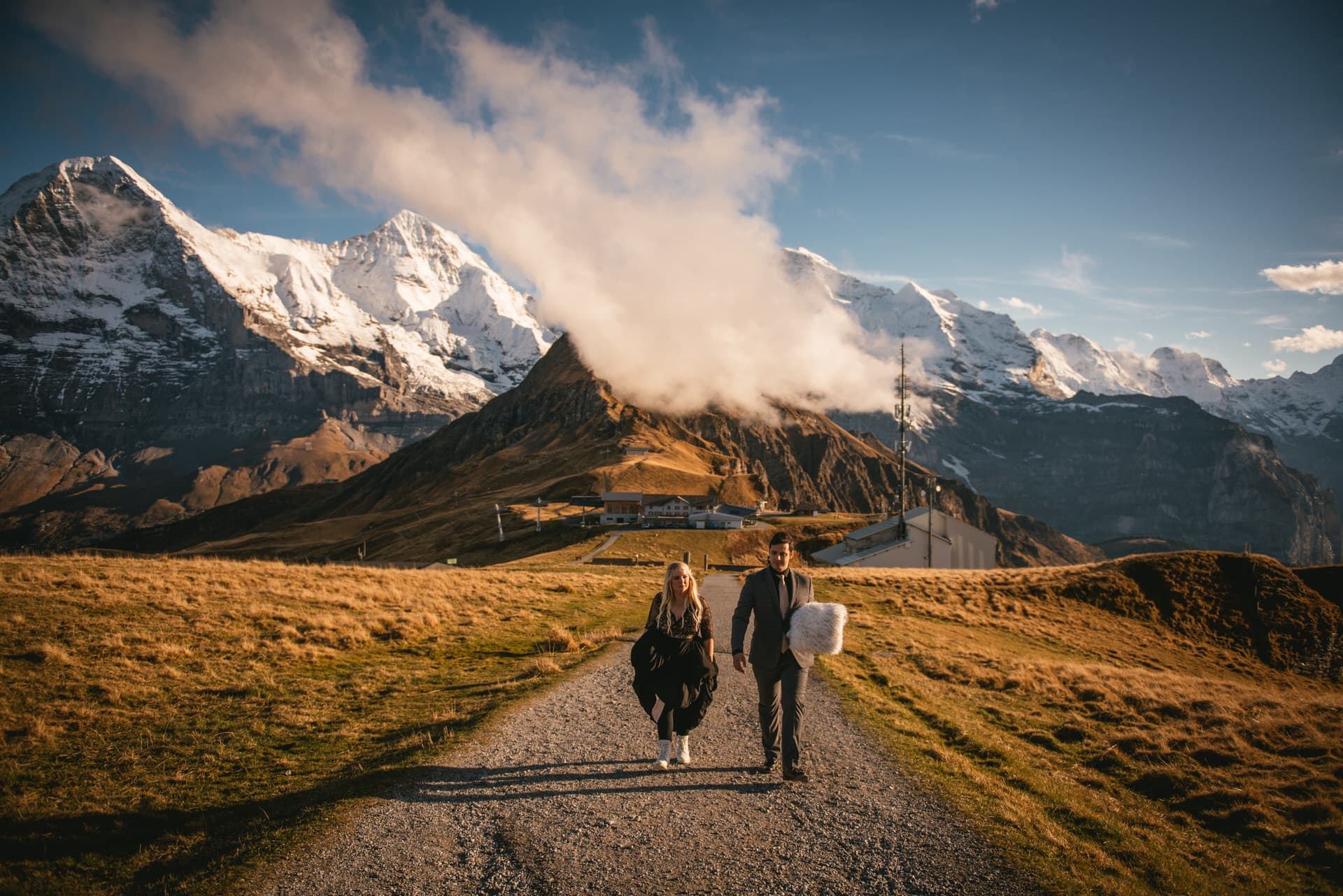Couple walking up to the mountaintop on their elopement day in Switzerland