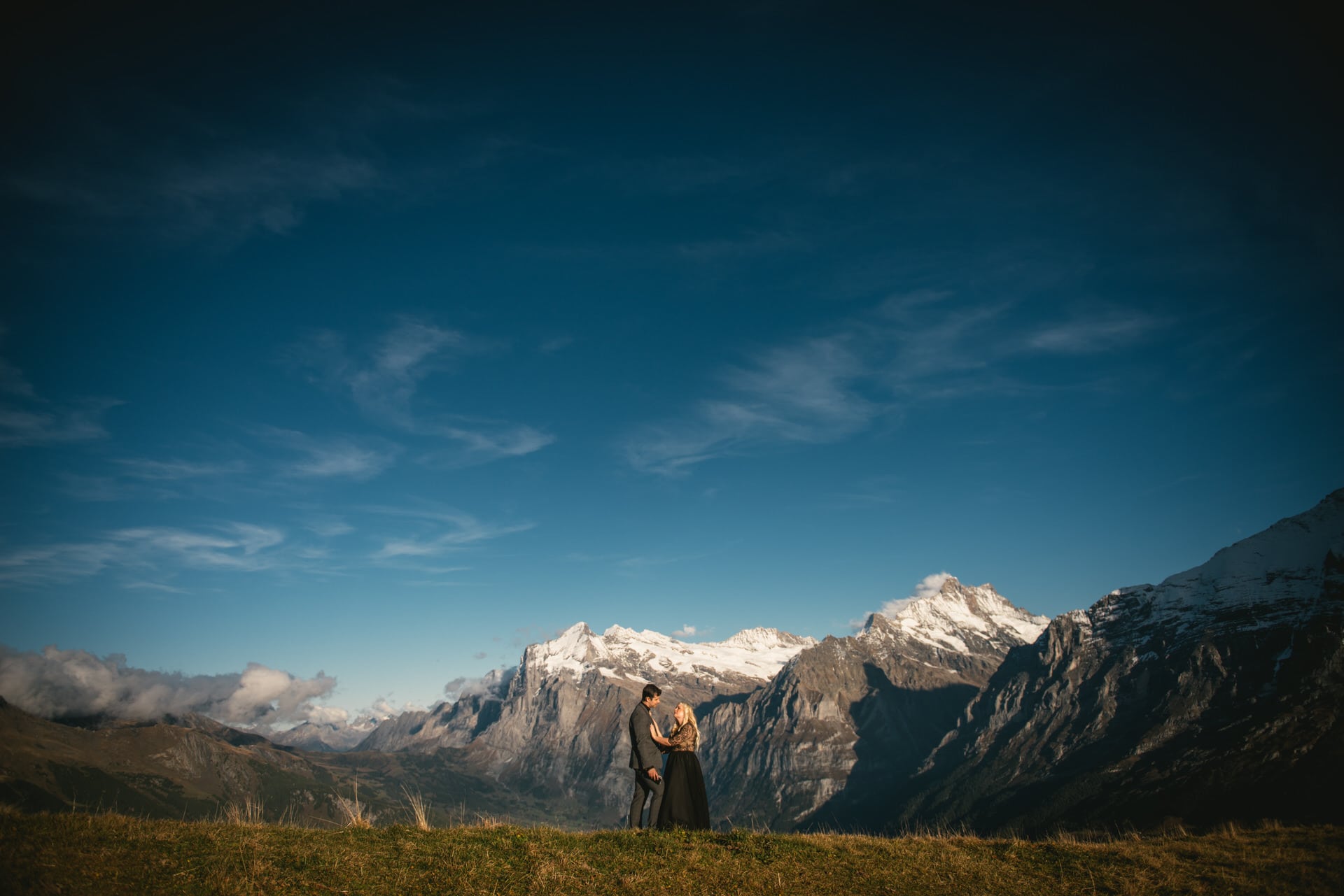 Couple exchanging their vows on top of the Mannlichen on their elopement day in Switzerland