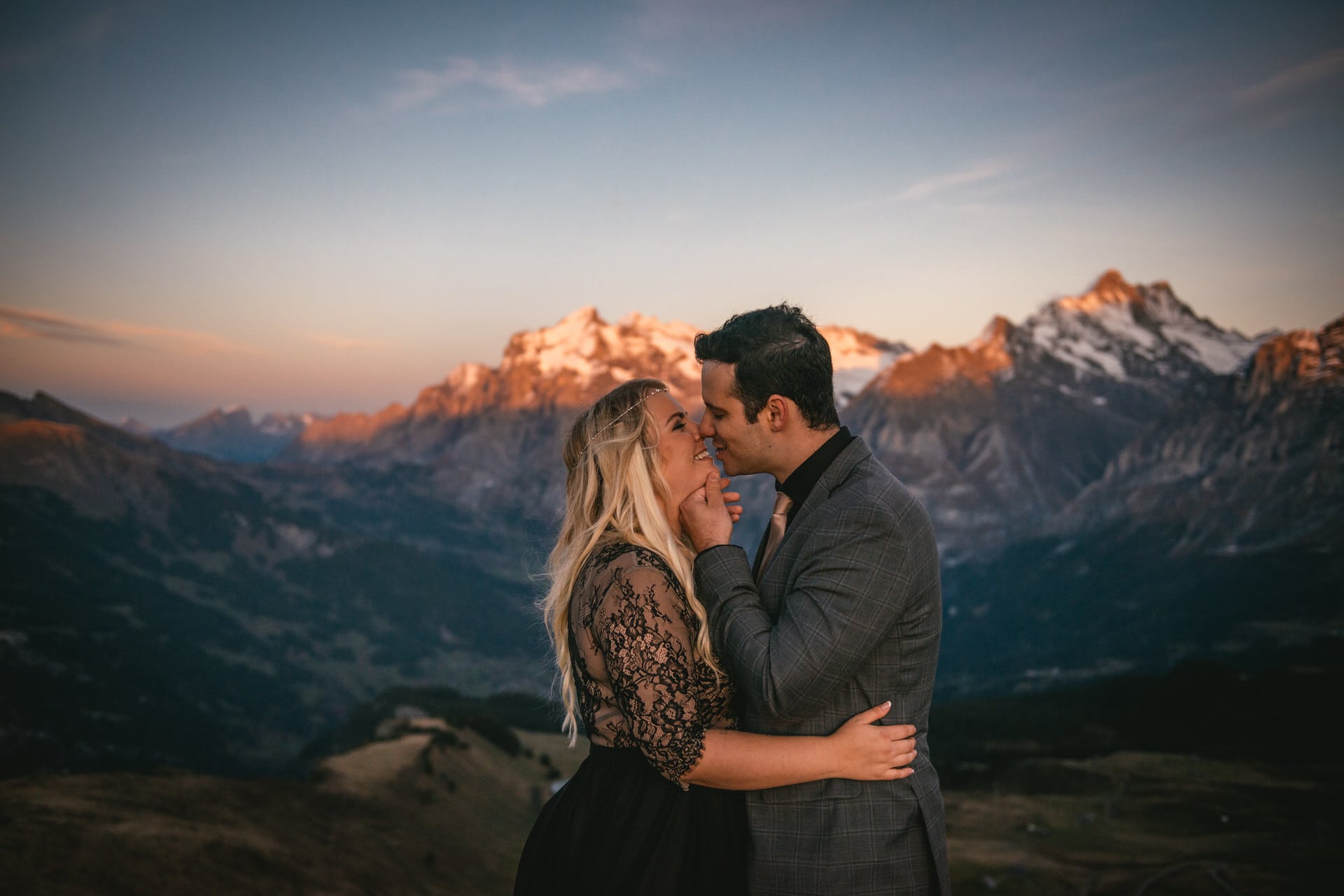 Couple enjoying the alpenglow in the Lauterbrunnen valley at sunset on their elopement day in Switzerland
